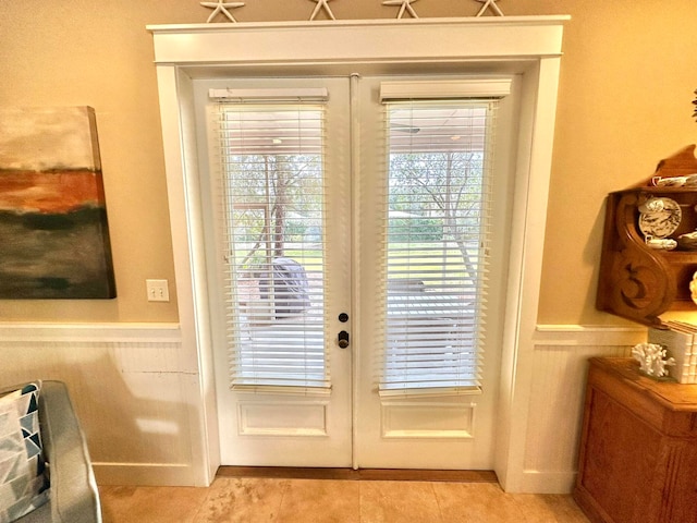 entryway featuring light tile patterned floors and french doors