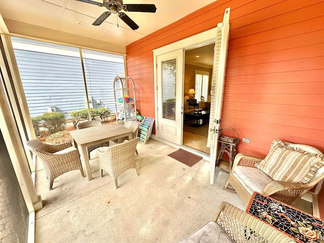 sunroom featuring ceiling fan