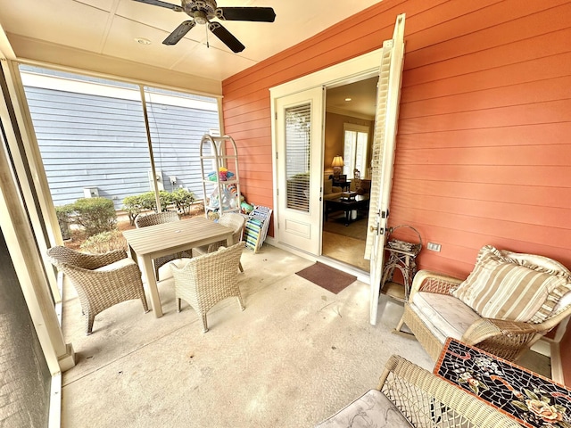 2450 Bungalo Ln, Miramar Beach, FL 32550 - sunroom / solarium with a ceiling fan, wood walls, carpet, and outdoor dining space