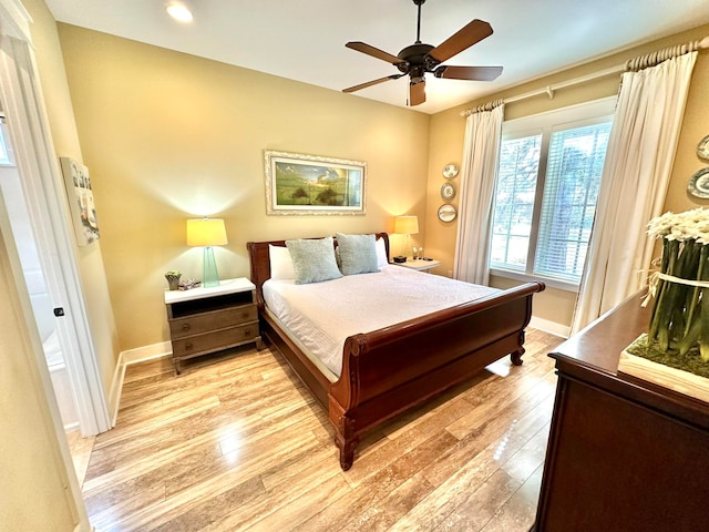 bedroom with ceiling fan and light hardwood / wood-style flooring