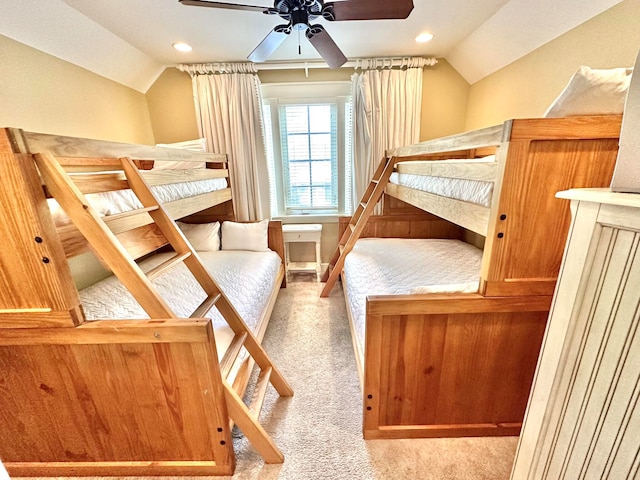 unfurnished bedroom with lofted ceiling, light colored carpet, and ceiling fan