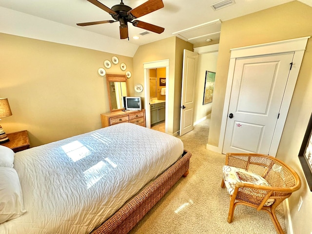 bedroom with light carpet, ceiling fan, and ensuite bathroom