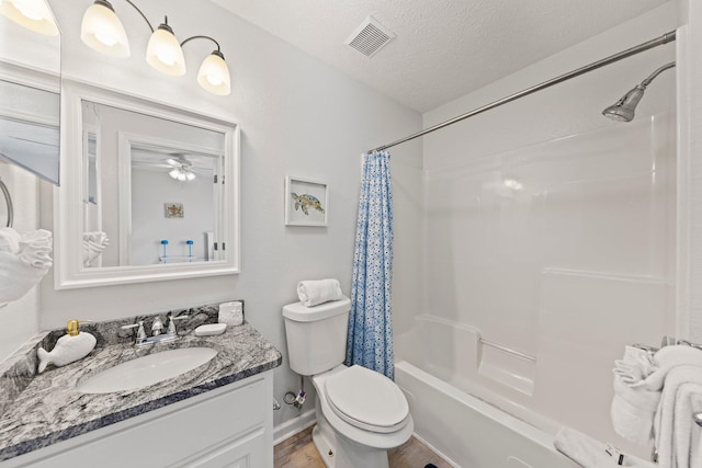 full bathroom featuring a textured ceiling, toilet, ceiling fan, shower / bath combo with shower curtain, and vanity