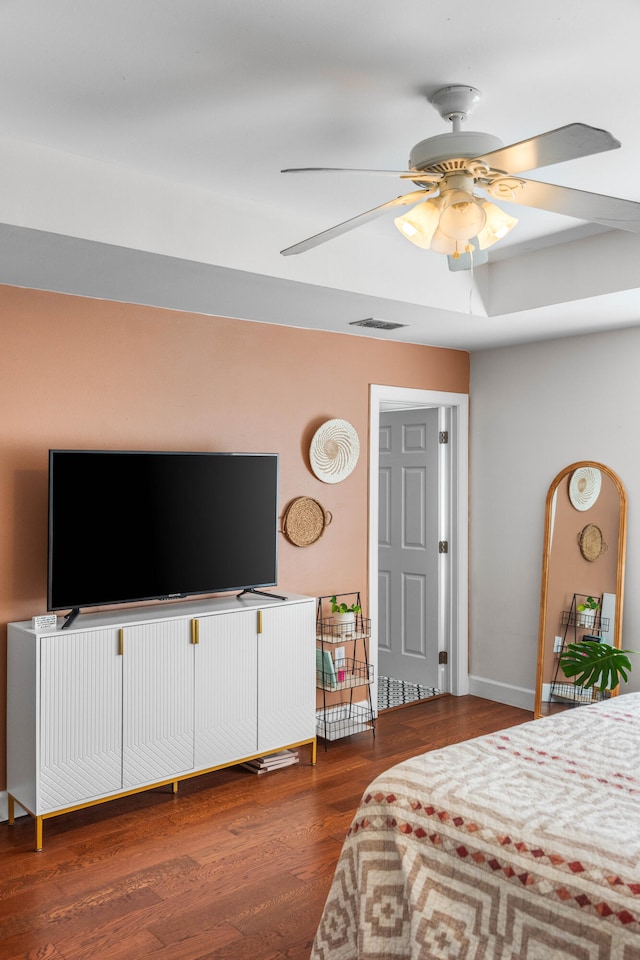 bedroom with ceiling fan and dark wood-type flooring