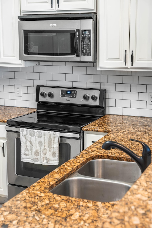 kitchen with appliances with stainless steel finishes and white cabinetry