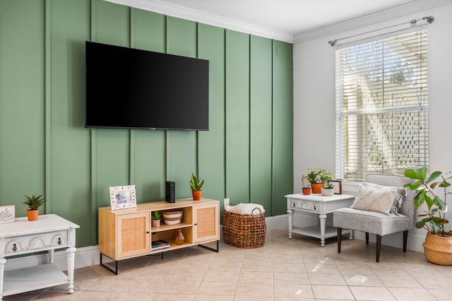 sitting room with light tile patterned floors and crown molding