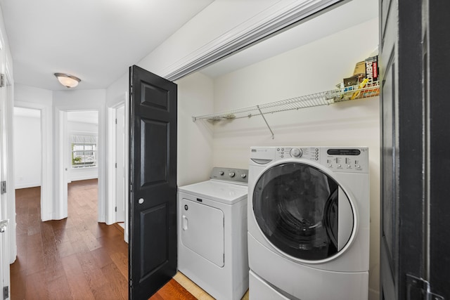 washroom featuring washer and dryer and dark hardwood / wood-style floors