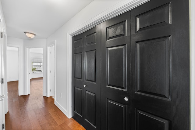 corridor with hardwood / wood-style floors