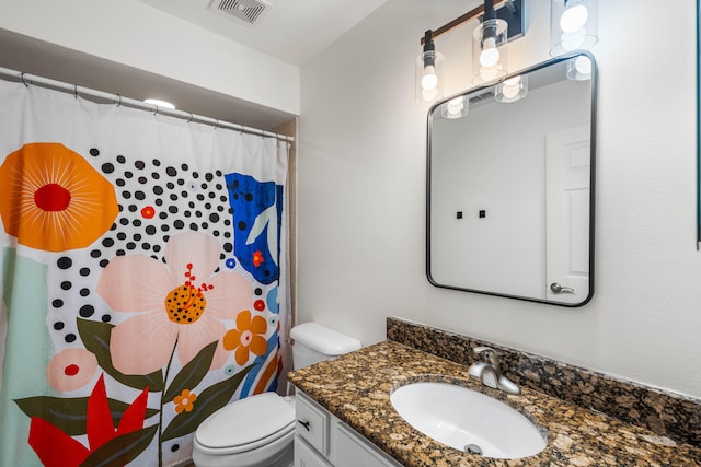 bathroom with vanity, curtained shower, and toilet