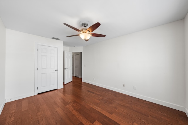 unfurnished bedroom with dark hardwood / wood-style flooring and ceiling fan