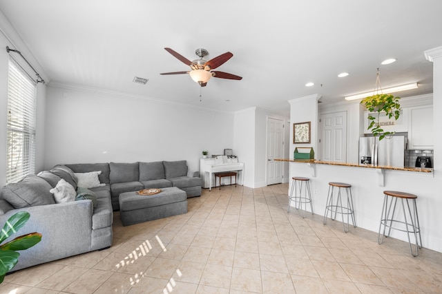 living room with ceiling fan, light tile patterned flooring, and crown molding