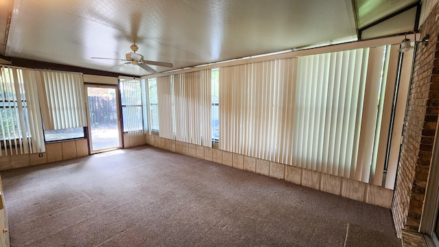 unfurnished sunroom featuring ceiling fan