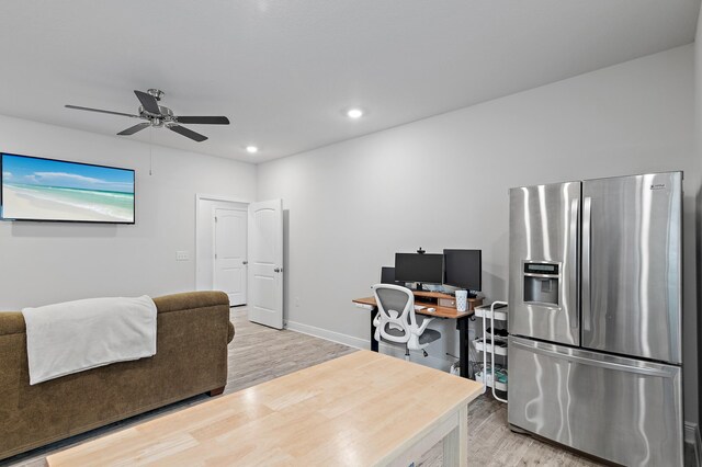 home office featuring wood-type flooring and ceiling fan