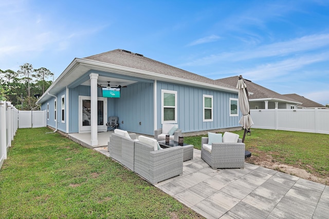 rear view of house featuring a lawn, ceiling fan, a patio, and an outdoor hangout area