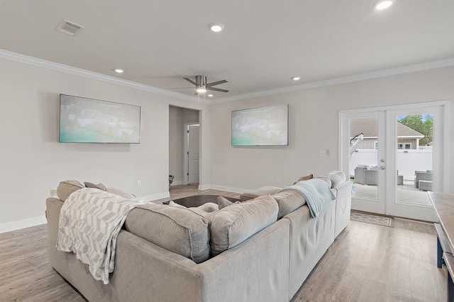 living room with french doors, light hardwood / wood-style floors, ceiling fan, and ornamental molding