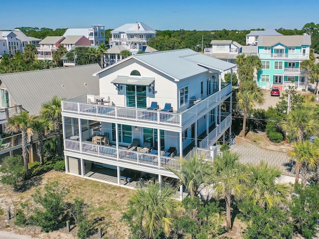 rear view of property featuring a balcony