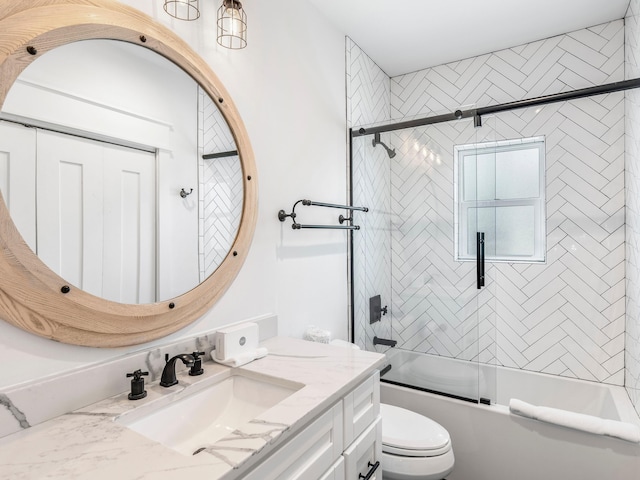 full bathroom with toilet, bath / shower combo with glass door, and vanity