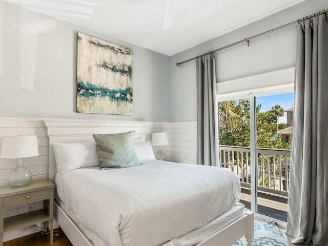 bedroom featuring access to outside, hardwood / wood-style flooring, and ceiling fan