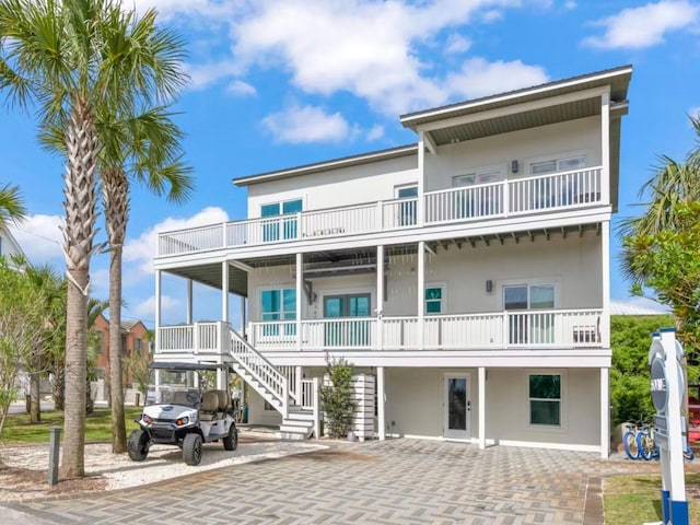 view of front of property featuring a carport and a balcony