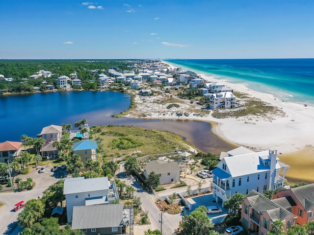 birds eye view of property featuring a water view and a beach view