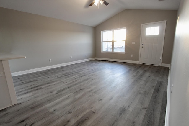 unfurnished living room featuring hardwood / wood-style flooring, ceiling fan, and vaulted ceiling