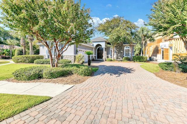 4705 Seastar Vis, Destin, FL 32541 - obstructed view of property featuring decorative driveway, stone siding, and stucco siding