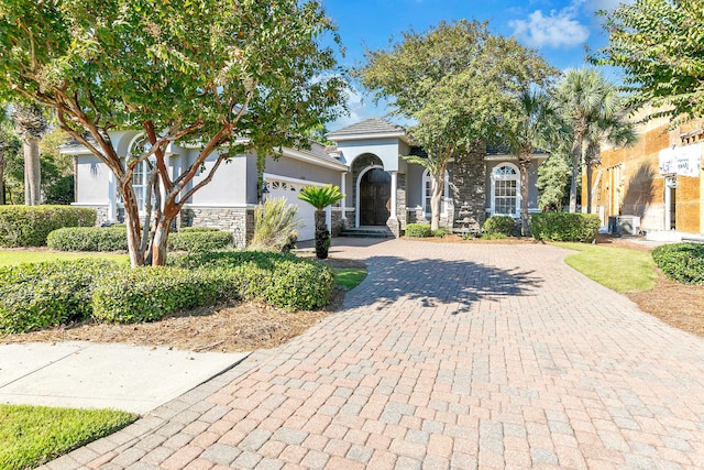 4705 Seastar Vis, Destin, FL 32541 - view of front of property with a garage, decorative driveway, stucco siding, and stone siding