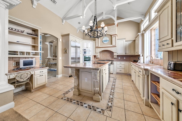 4705 Seastar Vis, Destin, FL 32541 - kitchen featuring arched walkways, open shelves, a sink, high vaulted ceiling, and cream cabinetry