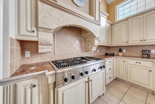 4705 Seastar Vis, Destin, FL 32541 - kitchen featuring stainless steel gas stovetop, cream cabinets, light tile patterned flooring, and tasteful backsplash