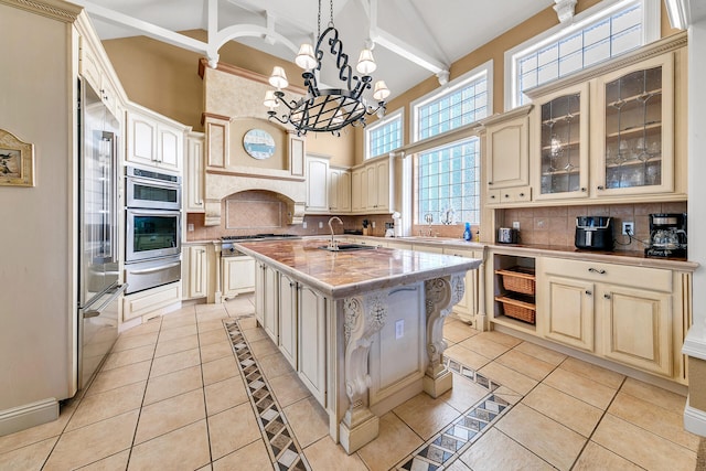 4705 Seastar Vis, Destin, FL 32541 - kitchen with a sink, a kitchen island with sink, a chandelier, cream cabinetry, and a warming drawer