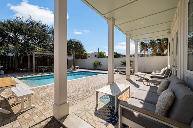 view of pool with a patio, outdoor lounge area, and a pergola