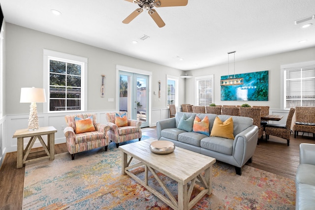 living room featuring wood-type flooring and ceiling fan