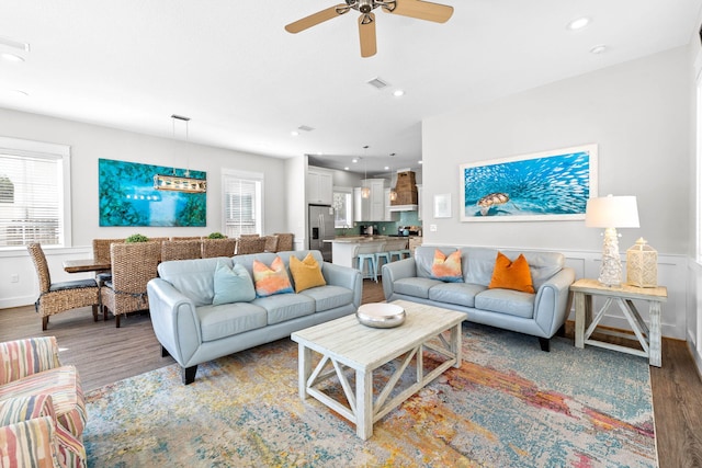 living room featuring hardwood / wood-style flooring and ceiling fan