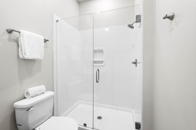 bathroom with toilet and walk in shower