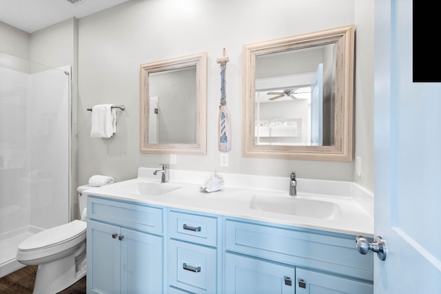 bathroom with toilet, hardwood / wood-style floors, a shower, vanity, and ceiling fan