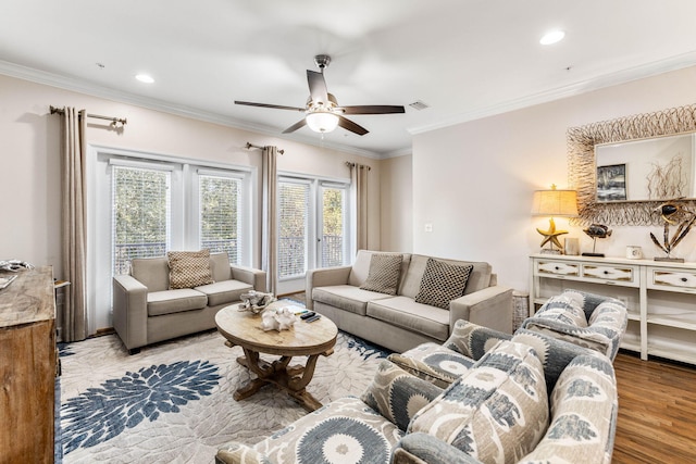 living room featuring ornamental molding, hardwood / wood-style flooring, and ceiling fan