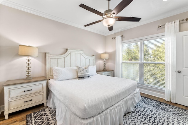 bedroom with crown molding, hardwood / wood-style floors, and ceiling fan