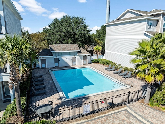 view of swimming pool with a patio area and an outbuilding