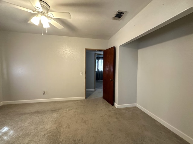 empty room with carpet floors and ceiling fan