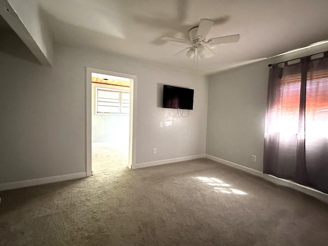 empty room with carpet floors and ceiling fan