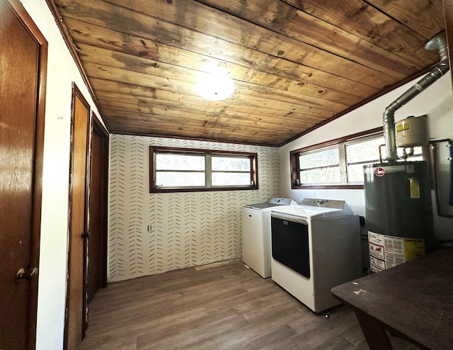 washroom with wood-type flooring, washer and clothes dryer, wooden ceiling, and water heater