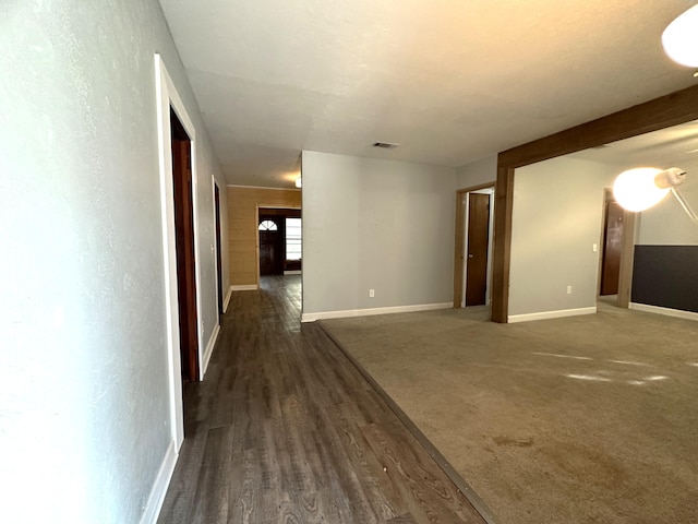 unfurnished room featuring dark wood-type flooring