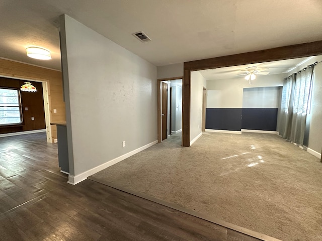 empty room featuring ceiling fan and dark wood-type flooring