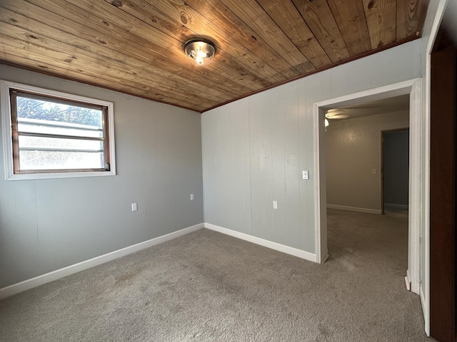 unfurnished room with crown molding, carpet floors, and wooden ceiling