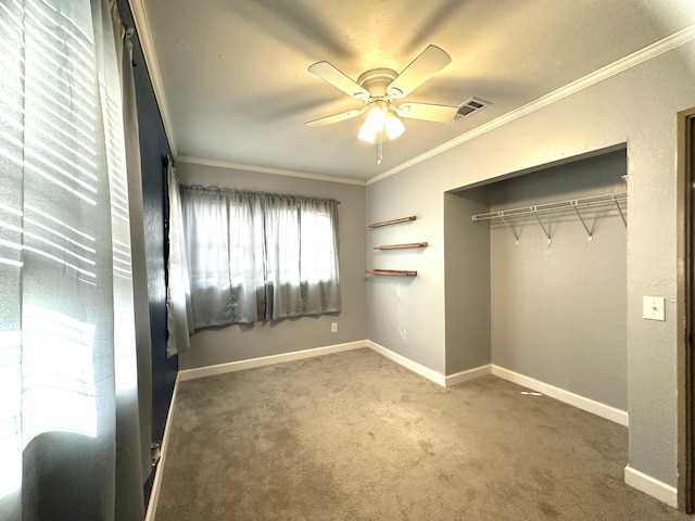 unfurnished bedroom featuring ceiling fan, a closet, carpet floors, and ornamental molding