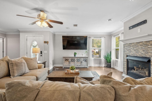 living room with ceiling fan, crown molding, and hardwood / wood-style floors