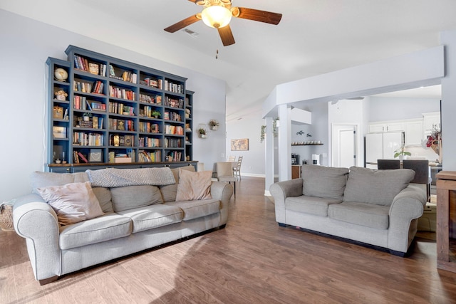 living room featuring ceiling fan, lofted ceiling, and dark hardwood / wood-style flooring