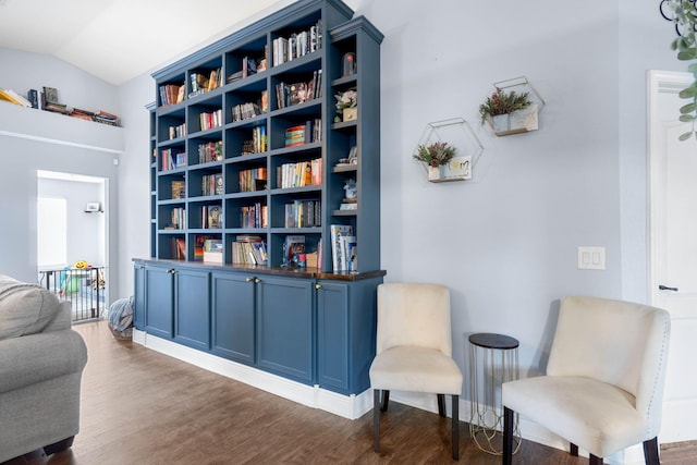 living area with dark wood-type flooring and vaulted ceiling