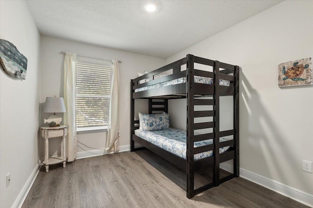 bedroom featuring a textured ceiling and hardwood / wood-style flooring