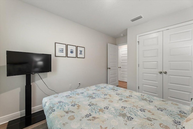 bedroom featuring dark hardwood / wood-style flooring and a closet